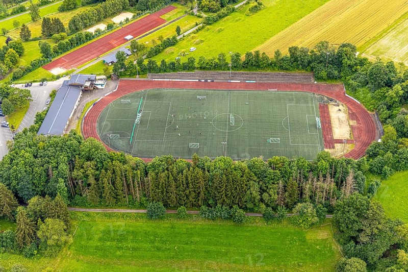 Aerial view, football stadium athletics stadium Auf dem Stöppel, sports field Bad Berleburg, youth players on the field, Bad Berleburg, Wittgensteiner Land, North Rhine-Westphalia, Germany, activity, architecture, athletes, Auf dem Stöppel, outdoor shot, leisure, football, football stadium, community, youth players, youth sport, landscape, athletics, athletics stadium, aerial view, grass, region, game, pitch, sport, sports facility, sports field, sports event, town, team, training, stands, surroundings, competition, competition venue