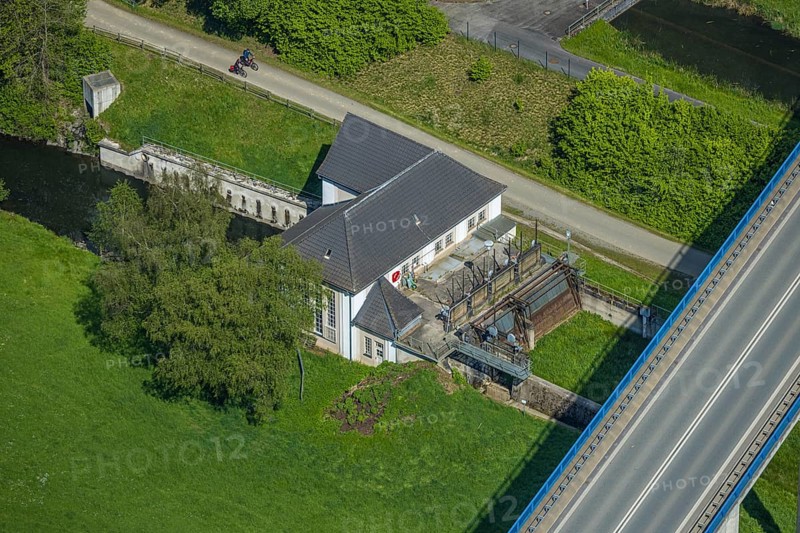Aerial view, Velmede hydroelectric power station at the Ruhr valley bridge Velmede, Velmede, Bestwig, Sauerland, North Rhine-Westphalia, Germany, hydroelectric power station, Ruhr valley bridge, river, bridge, aerial view, industrial structure, renewable energy, river landscape, architecture, technology, environment, green space, electricity, energy production, water, infrastructure, nature, technology, landscape, ecology, engineering, transport, water, village, energy supply, settlement, overpass, photography