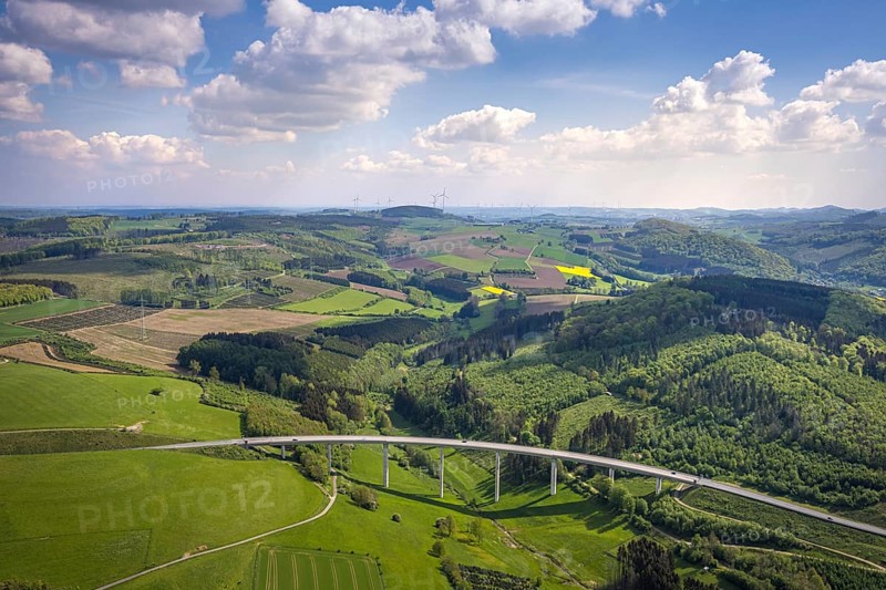 Aerial view, valley bridge Schormecke of the federal road B480 near Nuttlar, hilly landscape with meadows and fields, distant view, Nuttlar, Bestwig, Sauerland, North Rhine-Westphalia, Germany, valley bridge Schormecke, federal road B480, hilly landscape, meadows, fields, bridge, traffic, infrastructure, rural, nature, landscape, spring, summer, panorama, view, road traffic, structure, architecture, environment, region, village, infrastructure project, road traffic, traffic system, elevation, vegetation