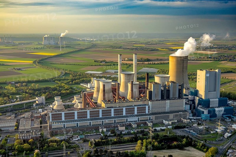 Aerial view, lignite-fired power plant Niederaußem, power plant site of RWE Power AG, cooling towers and smoke clouds, distant view, behind the RWE Power AG power plant Neurath, Bergheim, Rhineland, North Rhine-Westphalia, Germany, lignite-fired power plant, Niederaußem, RWE Power AG, cooling towers, smoke clouds, Neurath power plant, energy, industry, environment, smoke, emissions, pollution, technology, architecture, infrastructure, power generation, landscape, sky, clouds, perspective, air pollution, energy production, sustainability, coal power, ecological footprint, energy production, energy industry