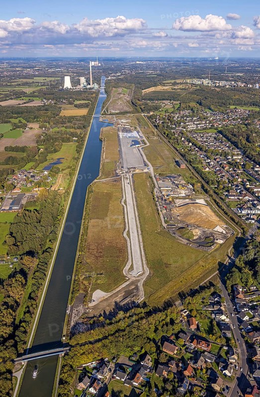 Aerial view, Wasserstadt Aden on the Datteln-Hamm Canal, construction area for planned urban quarter on the site of the former Haus Aden colliery, behind the Bergkamen power station, distant view and blue sky with clouds, Oberaden, Bergkamen, Ruhr area, North Rhine-Westphalia, Germany, Wasserstadt, Aden, Datteln-Hamm Canal, construction area, urban district, former colliery, Haus Aden, power station, distant view, blue sky, clouds, development, planning, industry, architecture, river, infrastructure, urban development, landscape, canal, energy, industrial area, urban, view, building, geography, environment, sky, cloud formations