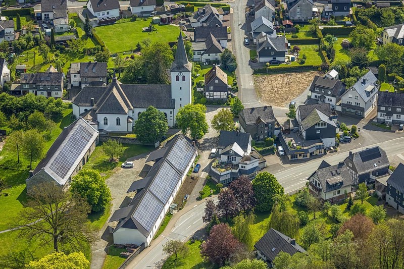 Aerial view, village centre, St. Joseph's Catholic Church, Kumm rin - Die Hofschänke with solar roof, Ostwig, Bestwig, Sauerland, North Rhine-Westphalia, Germany, Kumm rin - Die Hofschänke, solar roof, church, religion, architecture, solar energy, building, village, landscape, green spaces, streets, roofs, region, rural, infrastructure, community, photography, bird's eye view, village centre, renewable energies, autumn, daylight, historical, German village, residential buildings, trees, environmental protection