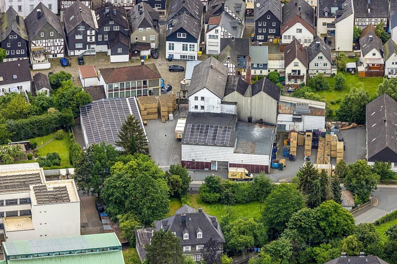 Aerial view, Bosch Brewery on the river Laasphe in a residential area, Bad Laasphe, Wittgensteiner Land, North Rhine-Westphalia, Germany, architecture, Bosch Brewery, roof, village, river, river Laasphe, building, industry, industrial area, infrastructure, landscape, aerial view, nature, perspective, summer, city, daytime, surroundings, company location, urban, forest, meadow, economy, residential area, rural, European, rural, medium-sized, regional