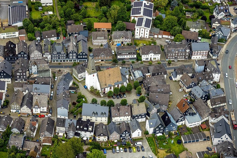 Aerial view, protestant town church and church square in the town centre with historic half-timbered houses, Bad Laasphe, Wittgensteiner Land, North Rhine-Westphalia, Germany, old town, architecture, treetops, village, roofs, buildings, history, green trees, sky, idyll, church square, church tower, culture, landscape, town centre, panorama, religion, sight, summer, city view, tourism, protestant town church, historic half-timbered houses, rural, traditional