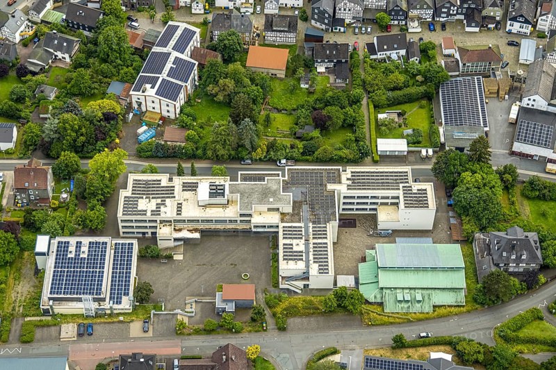 Aerial view, Städt. Gymnasium with solar roof, Bad Laasphe, sports hall TV Laasphe 1863 e.V., Wittgensteiner Land, North Rhine-Westphalia, Germany, architecture, exterior, education, educational centre, roof, village, facilities, building, community, infrastructure, landscape, sustainability, photovoltaic, school, solar roof, solar panels, sports, sports facility, sports hall, city view, TV Laasphe 1863 e.V., tag, technology, german architecture, renewable energy, european, modern, urban high school, environmentally friendly, ecology
