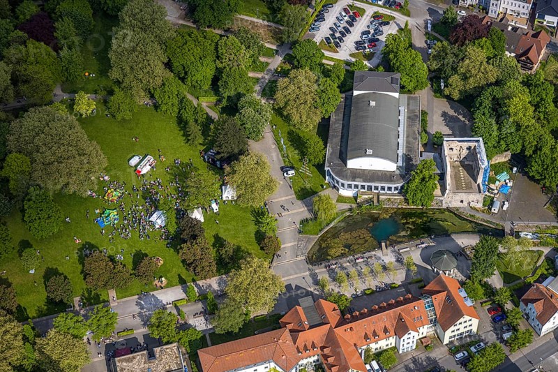 Aerial view, Congress Centre Bad Lippspringe, Arminius Park with castle ruins and river Lippequelle and Arminius Quelle Pavilion, Father's Day celebration in Arminius Park at the Congress Centre, visitors on the meadow, bouncy castle and drink stands, Bad Lippspringe, East Westphalia, North Rhine-Westphalia, Germany, Congress Centre, Arminius Park, castle ruins, river, Lippe spring, Arminius spring, pavilion, Father's Day festival, meadow, visitors, bouncy castle, drinks stands, event, celebration, leisure, open air, people, family, children, adults, culture, nature, park, architecture, history, tradition, town, landscape, green spaces, recreation, pleasure, summer, daylight, event, entertainment