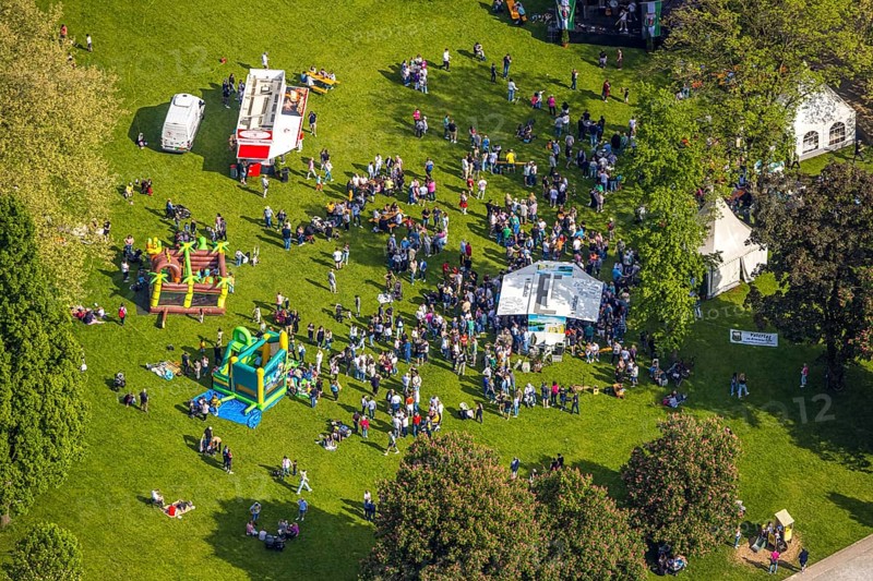 Aerial view, Father's Day festival in Arminiuspark at the Kongresshaus, visitors on the meadow, bouncy castle and drinks stands, Bad Lippspringe, East Westphalia, North Rhine-Westphalia, Germany, Father's Day festival, Arminiuspark, Kongresshaus, visitors, meadow, bouncy castle, drinks stands, leisure, celebration, spring, sunny, outdoors, people, family, children, adults, relaxation, leisure activity, event, culture, green space, park, event, gathering, fun, recreation, community, traditional, landscape, city, urban