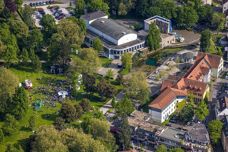 Aerial view, Congress Centre Bad Lippspringe, Arminius Park with castle ruins and river Lippequelle and Arminius Quelle Pavilion, Father's Day celebration in Arminius Park at the Congress Centre, visitors on the meadow, bouncy castle and drink stands, Bad Lippspringe, East Westphalia, North Rhine-Westphalia, Germany, Congress Centre, Arminius Park, castle ruins, river, Lippequelle, Arminius Spring Pavilion, Father's Day festival, visitors, meadow, bouncy castle, drinks stands, park, celebration, people, family, children, adults, leisure, entertainment, culture, nature, green space, trees, riverbank, architecture, historical, event, outdoors, daylight, spring, summer, joy, community, recreation, landscape