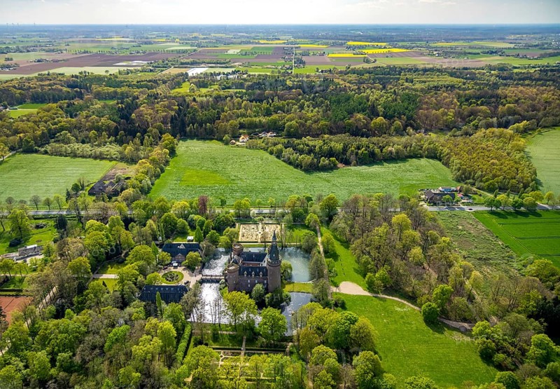 Aerial view, Museum Schloss Moyland, neo-Gothic moated castle and castle park surrounded by meadows and fields and forest, excursion destination on the Lower Rhine, Moyland, Bedburg-Hau, Lower Rhine, North Rhine-Westphalia, Germany, architecture, excursion destination, exterior view, visitor destination, trees, recreation, fields, leisure, peace, history, green spaces, idyll, culture, cultural heritage, landscape, aerial view, nature, perspective, castle park, beauty, sight, daylight, tourism, forest, meadows, historic building, neo-gothic moated castle