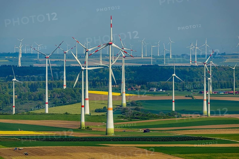 Aerial view, wind park and wind farm wind energy plant, wind turbines and rape fields near Radlinghausen, Messinghausen, Brilon, East Westphalia, Sauerland, North Rhine-Westphalia, Germany, wind park, wind farm, wind energy plant, wind turbines, rape fields, Radlinghausen, renewable energy, landscape, fields, country, green, yellow, agriculture, nature, environment, sustainable energy, technology, infrastructure, power generation, aerial view, spring, blooming, hill, rural, panoramic view, turbines, rural scene, power generation, ecology