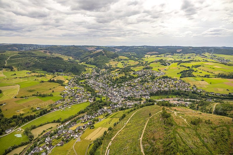 Aerial view, view of Feudingen residential area, hilly landscape with meadows and fields and distant view, sky with clouds, Feudingen, Bad Laasphe, Wittgensteiner Land, North Rhine-Westphalia, Germany, view, trees, village, Europe, fields, distant view, building, green, sky, houses, hilly landscape, idyllic, infrastructure, landscape, agriculture, nature, local view, panorama, region, settlement, summer, roads, daylight, meadows, residential area, clouds, peaceful, rural, quiet