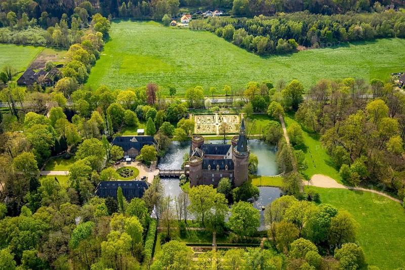 Aerial view, Museum Schloss Moyland, neo-Gothic moated castle and castle park surrounded by meadows and fields and forest, excursion destination on the Lower Rhine, Moyland, Bedburg-Hau, Lower Rhine, North Rhine-Westphalia, Germany, architecture, excursion destination, trees, recreation, fields, leisure, leisure activities, history, green spaces, idyllic, culture, landscape, nature, castle park, beauty, sight, daylight, tourism, forest, water, meadows, European, peaceful, historical, cultural, neo-Gothic moated castle