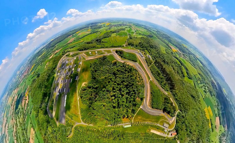 Aerial view, Bilster Berg race track, test track and presentation track, park-like terrain with paddock and off-road course, globe, fisheye image, fisheye image, 360 degree image, tiny world, little planet, Pömbsen, Bad Driburg, East Westphalia, North Rhine-Westphalia, Germany, test track, presentation track, park-like, terrain, paddock, off-road course, fisheye image, track, circuit, motorsport, landscape, trees, nature, automobile, racing, bird's eye view, panorama, circle, round, sky, outdoor, technology, innovation, architecture, infrastructure