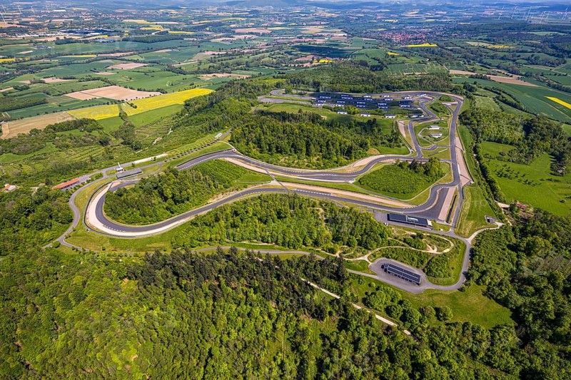 Aerial view, Bilster Berg race track, test track and presentation track, park-like terrain with paddock and off-road course, Pömbsen, Bad Driburg, East Westphalia, North Rhine-Westphalia, Germany, Bilster Berg, race track, test track, presentation track, park-like, paddock, off-road course, terrain, motorsport, facility, green spaces, trees, landscape, leisure, sport, vehicles, training, asphalt, slopes, track layout, nature, outdoor, recreation, open-air, venue, technology, perspective, infrastructure