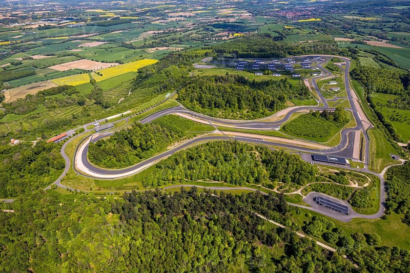 Aerial view, Bilster Berg race track, test track and presentation track, park-like terrain with paddock and off-road course, Pömbsen, Bad Driburg, East Westphalia, North Rhine-Westphalia, Germany, Bilster Berg, race track, test track, presentation track, park-like, paddock, off-road course, terrain, motorsport, nature, green spaces, trees, landscape, top view, leisure, activity, vehicles, track layout, asphalt, sport, outdoor, facility, technology, design, infrastructure, transport, movement, speed, competition, recreation