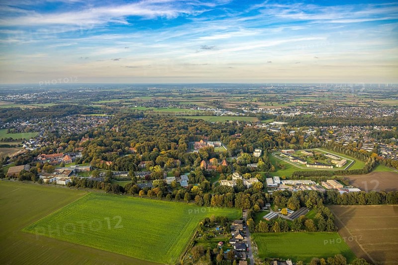 Aerial view, view LVR-Klinik Bedburg-Hau clinic grounds in autumnal forest, right Forensic Psychiatry - LVR-Klinik buildings F1 to F7, distant view and blue sky, Schneppenbaum, Bedburg-Hau, Lower Rhine, North Rhine-Westphalia, Germany, LVR-Klinik Bedburg-Hau, clinic grounds, autumn, forest, Forensic psychiatry, building F1, building F7, distant view, blue sky, architecture, healthcare, nature, facilities, trees, leaves, season, panorama, scenic, medical, institution, regions, environment, exterior view, building, infrastructure, peaceful, extensive, bird's eye view, clarity