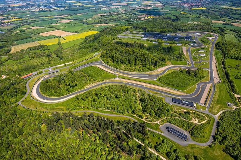 Aerial view, Bilster Berg race track, test track and presentation track, park-like terrain with paddock and off-road course, Pömbsen, Bad Driburg, East Westphalia, North Rhine-Westphalia, Germany, Bilster Berg, race track, test track, presentation track, park-like, paddock, off-road course, terrain, motorsport, facility, nature, green space, vehicles, routing, curves, asphalt, leisure, sport, landscape, hills, trees, outdoor, panorama, aerial view, technology, infrastructure, recreation, event location, tourism, sight, architecture, planning, building