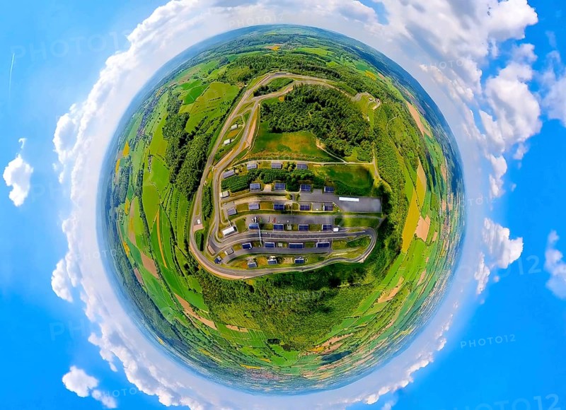 Aerial view, Bilster Berg race track, test track and presentation track, park-like terrain, paddock with solar roofs, globe, fisheye image, fisheye image, 360 degree image, tiny world, little planet, fisheye image, Pömbsen, Bad Driburg, East Westphalia, North Rhine-Westphalia, Germany, test track, presentation track, park-like, terrain, paddock, solar roofs, solar systems, fisheye, fisheye, 360 degree, race track, motorsport, landscape, nature, technology, energy efficiency, renewable energies, modern design, infrastructure, environment, sustainability, aerial view, drone image, topographical, car, vehicle