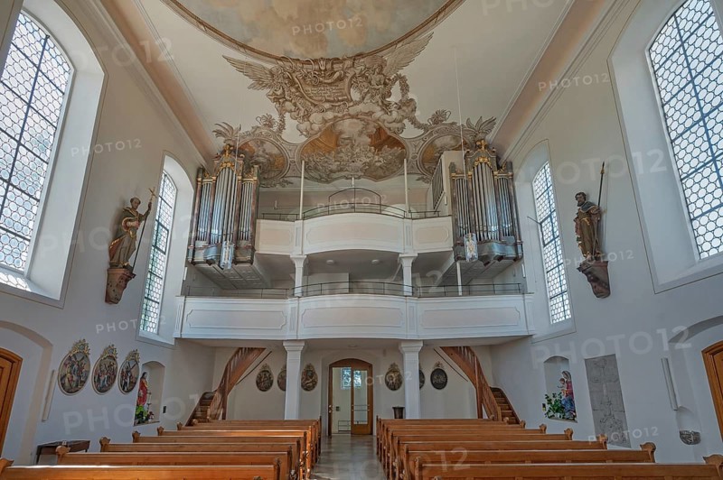 Interior of the Roman Catholic parish church of the Assumption of the Virgin Mary with organ loft and ceiling frescoes in Gebrazhofen, district of the large district town of Leutkirch im Allgäu, district of Ravensburg, Baden-Württemberg, Germany