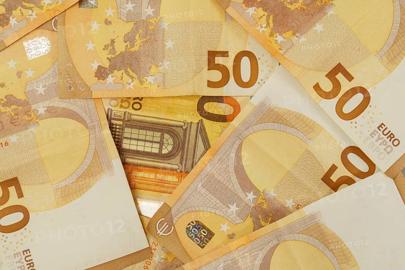 Multiple 50 euro banknotes creating an abstract financial background