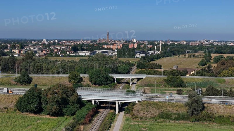 Panoramic view of Cremona skyline and agricultural landscape near a Northern Italian city under a clear blue sky