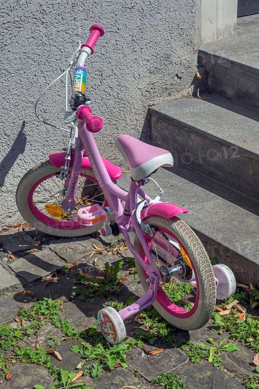 Pink-coloured Unicorn children's bike with training wheels, Dornbirn, Vorarlberg, Austria