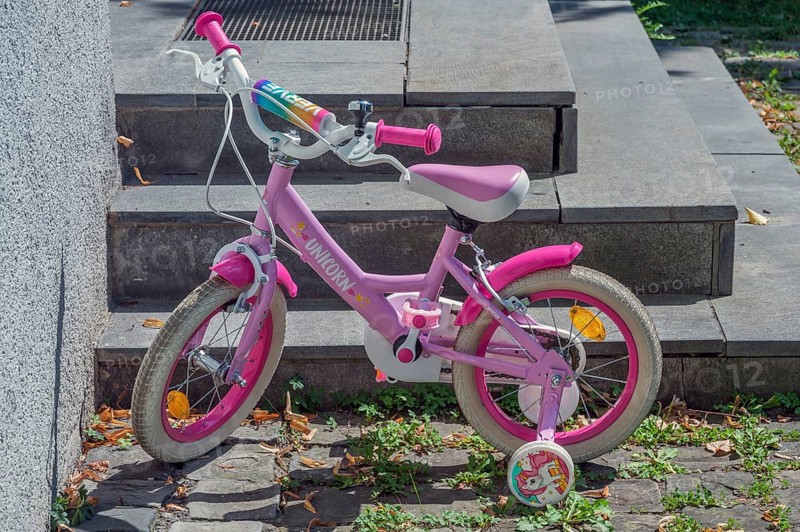Pink-coloured Unicorn children's bike with training wheels, Dornbirn, Vorarlberg, Austria