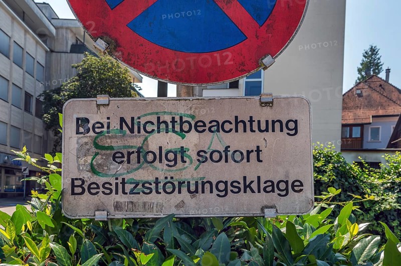 No stopping sign with the notice In the event of non-compliance, immediate action for possession will be taken, Dornbirn, Vorarlberg, Austria
