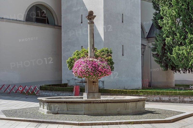 St Martin's Fountain with floral decorations at the parish church of St Martin, Dornbirn, Vorarlberg, Austria