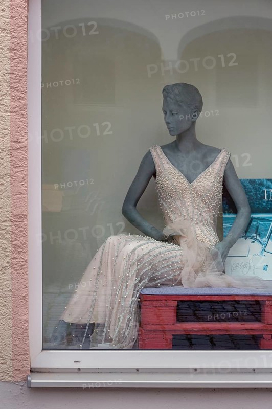 Shop window with grey fashion mannequin in evening dress, Bavaria, Germany