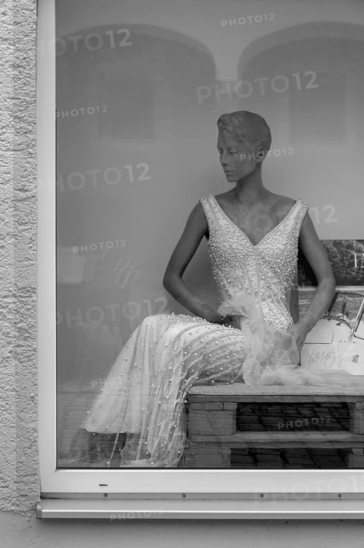 Shop window with grey fashion mannequin in evening dress, Bavaria, Germany