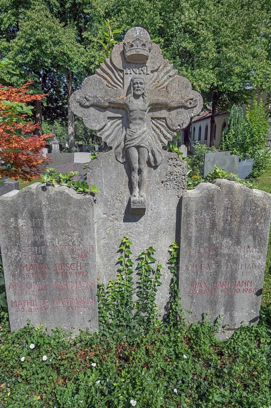 Gravesite with stone crucifix and ivy, catholic cemetery, Kempten, Allgäu, Bavaria, Germany