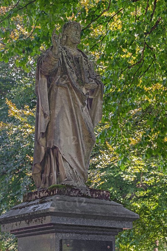 Gravesite with weathered figure of Christ blessing, catholic cemetery, Kempten, Allgäu, Bavaria, Germany