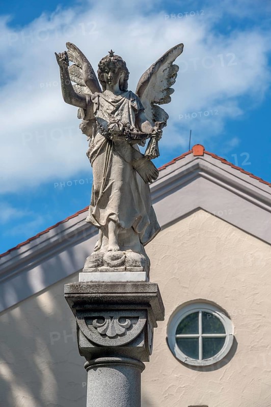 The angel on the fountain column by the funeral parlour, Catholic cemetery, Kempten, Allgäu, Bavaria, Germany