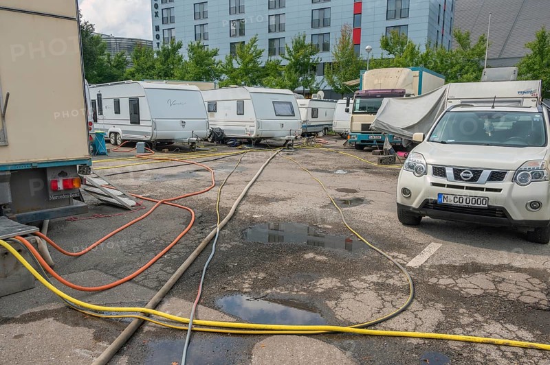 Parked caravans with tangle of water hoses, Circus-Krone, Kempten, Allgäu, Bavaria, Germany