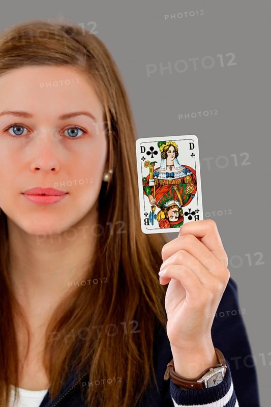 Woman holding a playing card in her hand