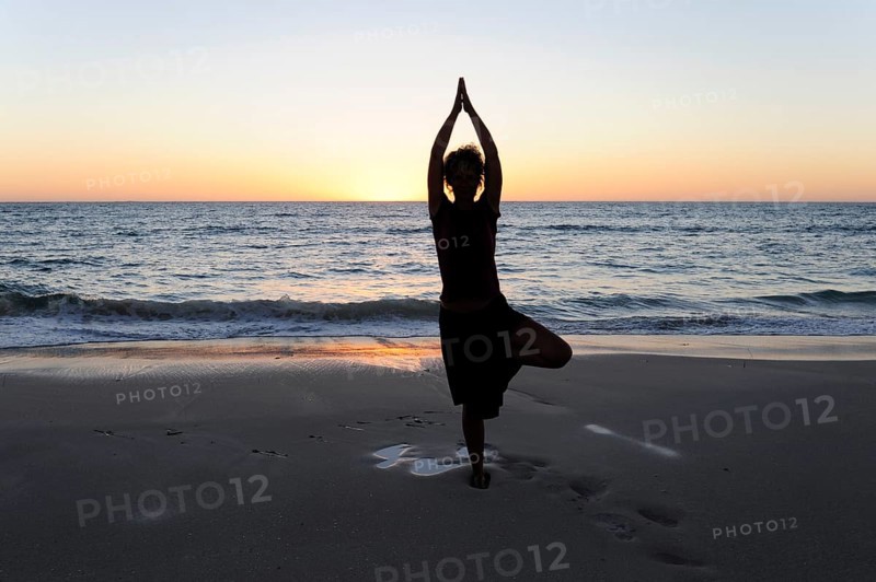 Yoga position, woman showing asana on the beach at Cervantes, Perth, Western Australia, WA, Indian Ocean, Australia