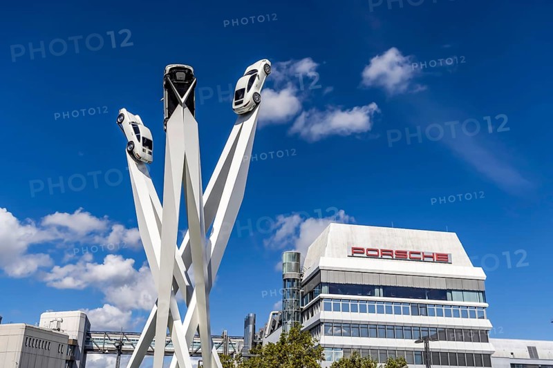 Stuttgart Zuffenhausen with headquarters and logo. Inspiration 911 artwork by Gerry Judah on Porscheplatz: three pillars, each up to 24 metres high, presenting a Porsche 911. Stuttgart, Baden-Württemberg, Germany