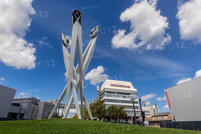 Stuttgart Zuffenhausen with headquarters and logo. Inspiration 911 artwork by Gerry Judah on Porscheplatz: three pillars, each up to 24 metres high, presenting a Porsche 911. Stuttgart, Baden-Württemberg, Germany