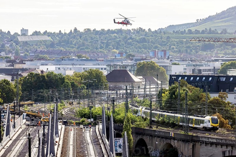 Track construction from the air. At Bad Cannstatt railway station, a transport helicopter transports 26 catenary masts to their destination. The masts, weighing up to 2.4 tonnes, were delivered by rail. The reason for this is to improve the infrastructure as part of the Stuttgart 21 project. Stuttgart, Baden-Württemberg, Germany