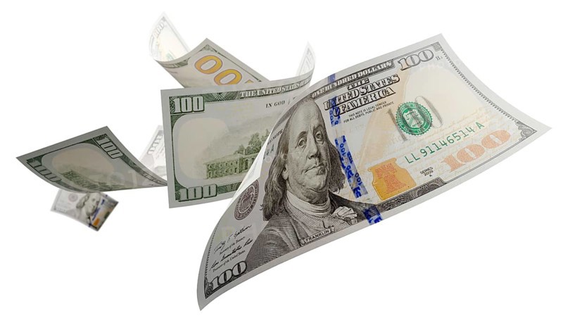 Randomly falling U.S. 100 dollar bills isolated on a white background