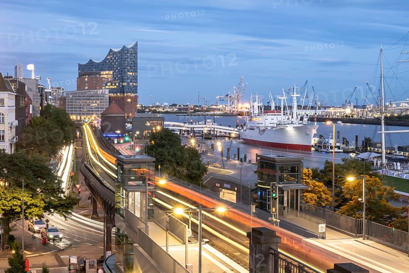 View of the harbour of Hamburg with Landungsbrücken, Jan-Fedder-Promenade, Cap San Diego, light traces of the underground U3 and the Elbphilharmonie at blue hour, Hamburg, Germany