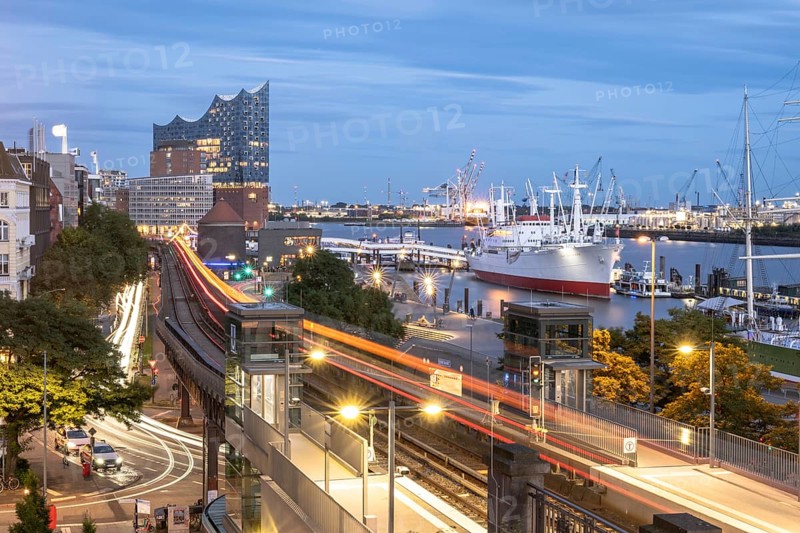 View of the harbour of Hamburg with Landungsbrücken, Jan-Fedder-Promenade, Cap San Diego, light traces of the underground U3 and the Elbphilharmonie at blue hour, Hamburg, Germany