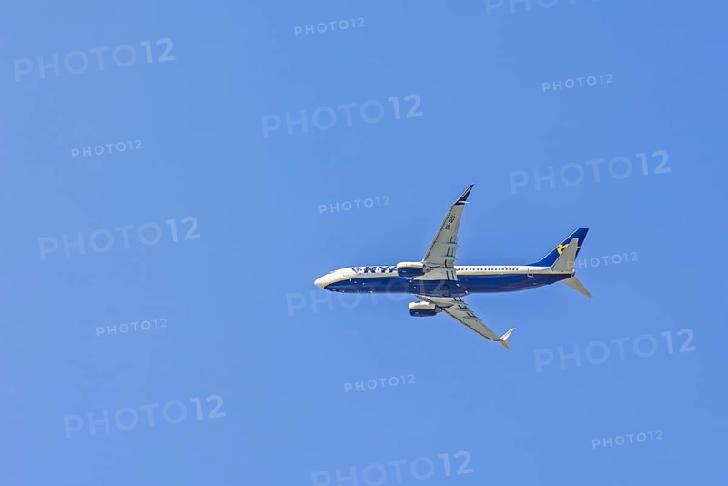 Ryanair passenger plane flying on the blue sky