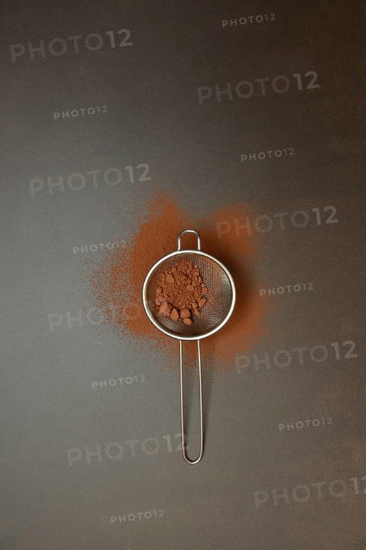 Kitchen sieve with cocoa powder, cocoa