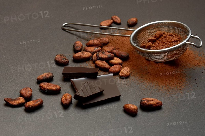 Kitchen sieve with cocoa powder and chocolate, cocoa and cocoa beans