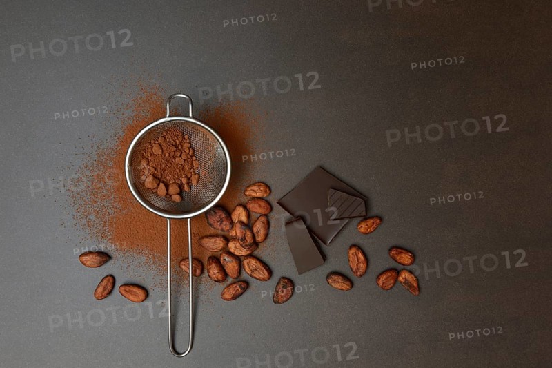 Kitchen sieve with cocoa powder and chocolate, cocoa and cocoa beans
