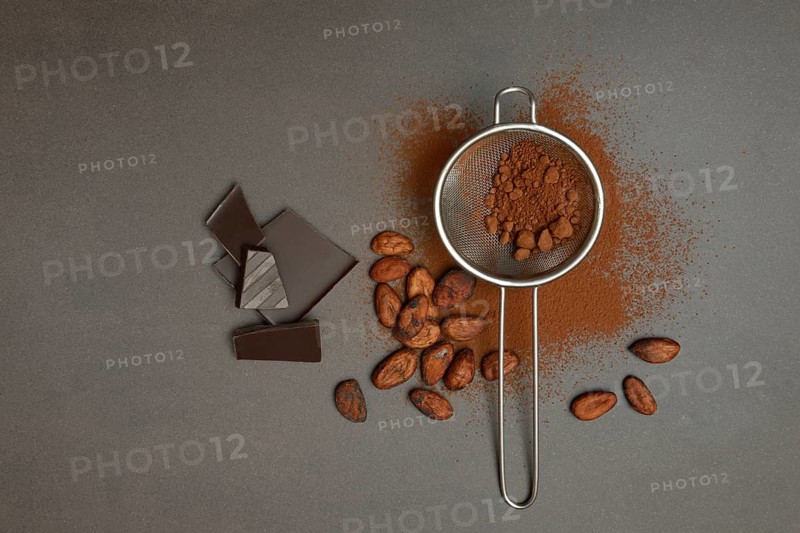 Kitchen sieve with cocoa powder and chocolate, cocoa and cocoa beans