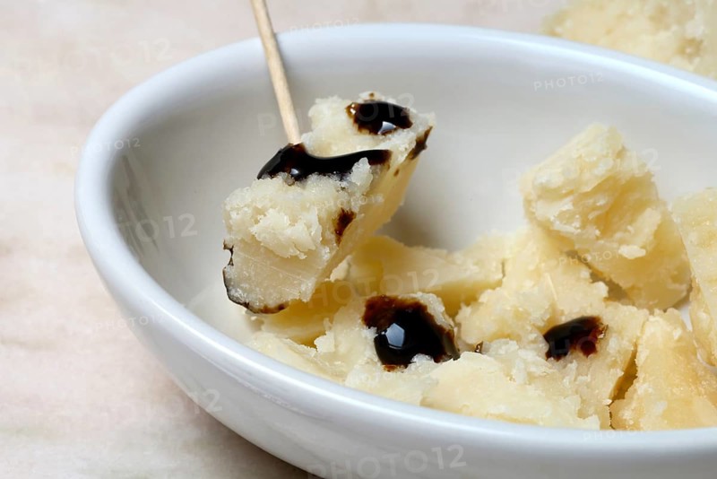 Parmesan cheese, pieces of cheese with crema di balsamico in small bowls