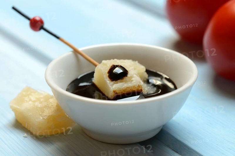 Parmesan cheese, pieces of cheese with crema di balsamico in small bowls